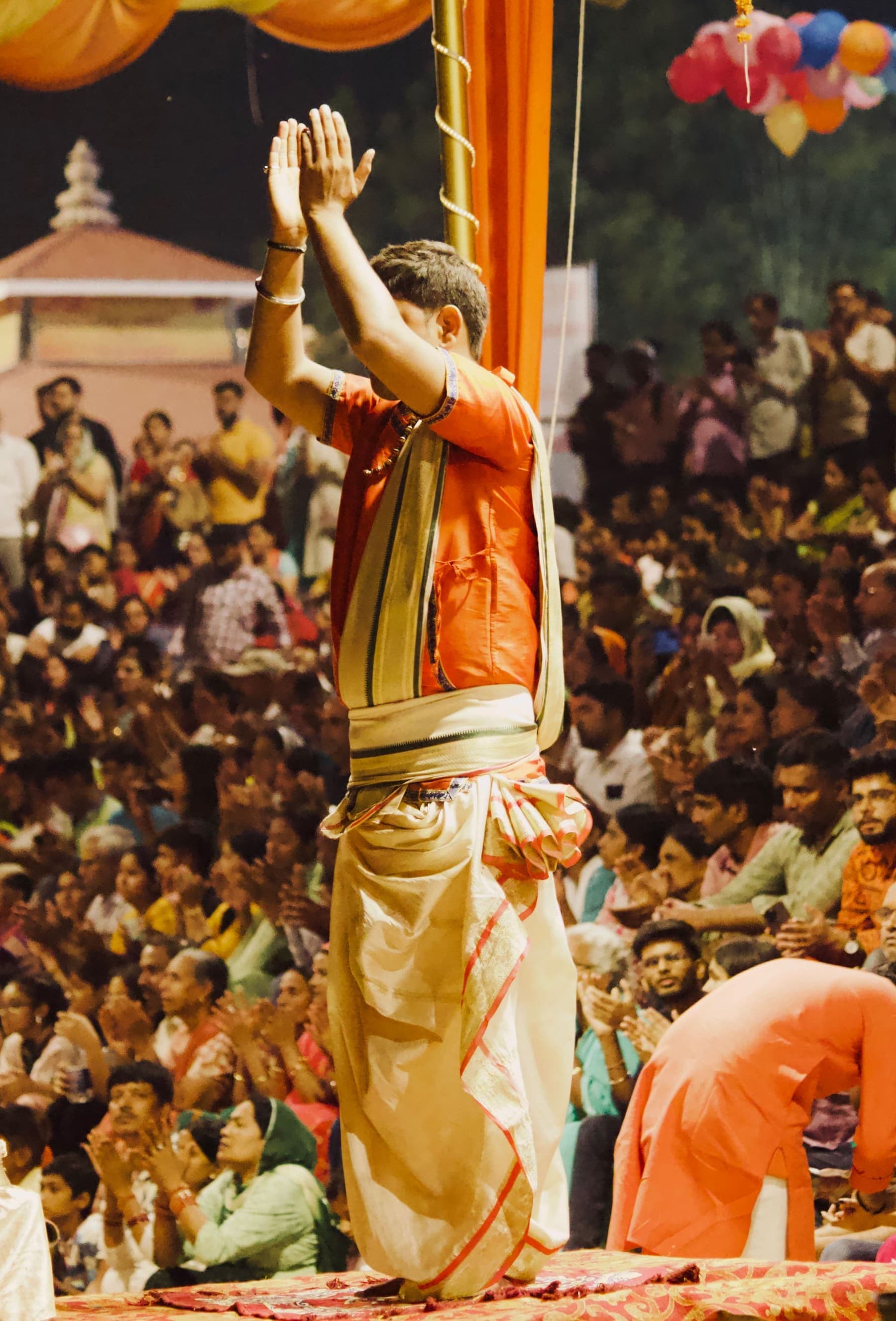 A priest leads the evening Aarti before a crowd on the ghats of Varanasi